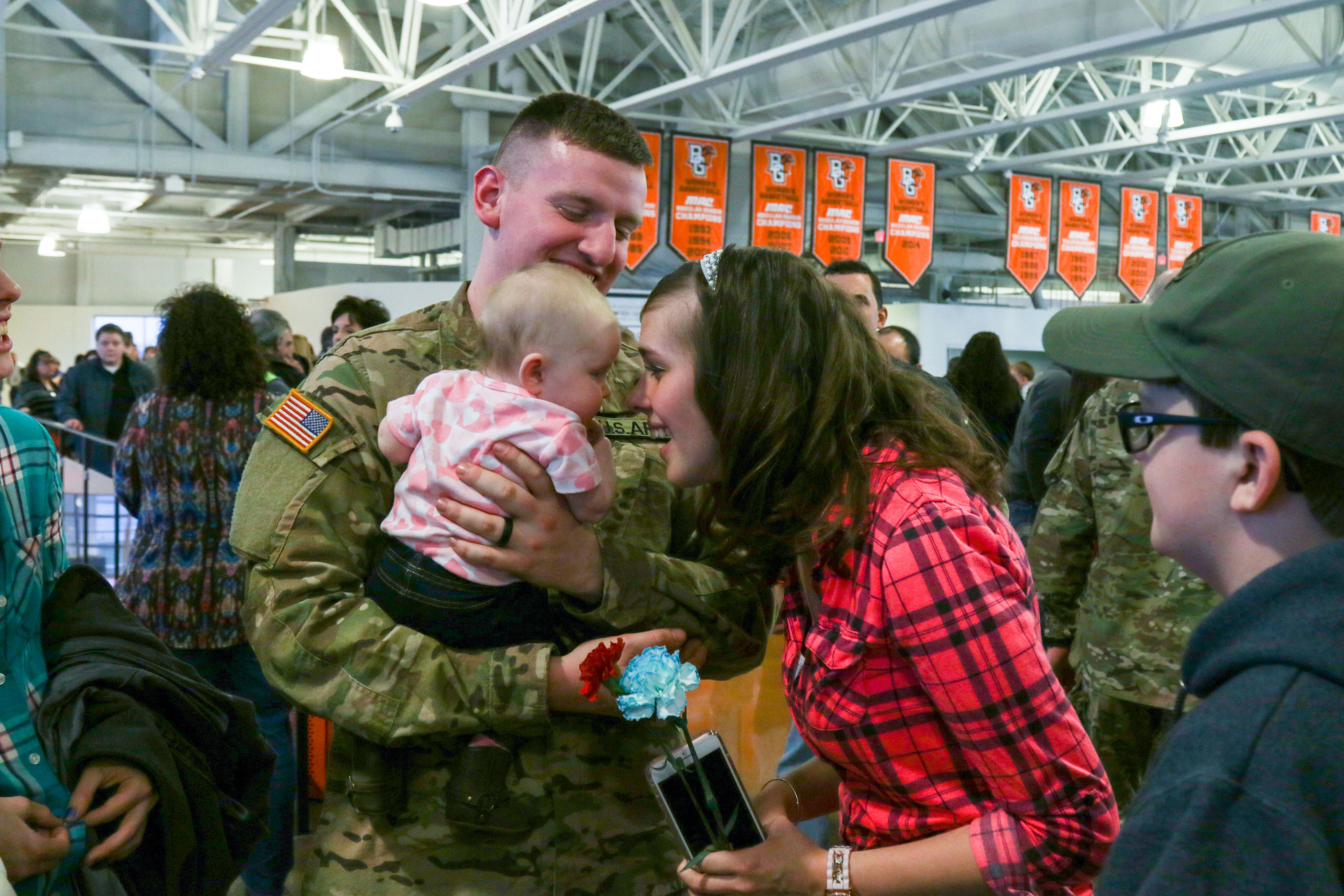 A  Soldier assigned to the 1st Battalion, 148th Infantry Regiment spends time with his Family after the unit’s call to duty ceremony Jan. 11, 2017, in Bowling Green, Ohio.  (Ohio National Guard/ Michael Carden)