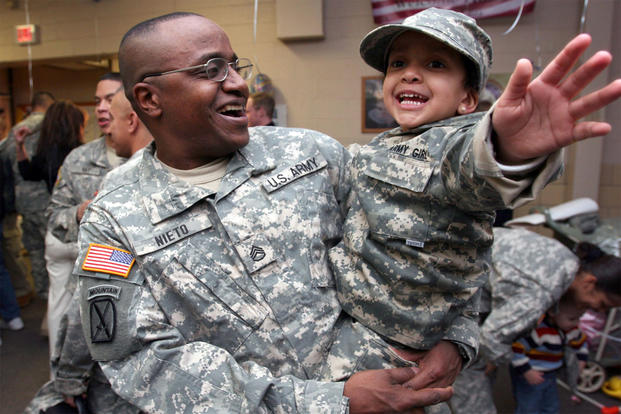Staff Sgt. Antonio Nieto, 50th Personnel Services Battalion, New Jersey Army National Guard, laughs with his daughter, Antonella, after returning from a year-long tour in Afghanistan in support of Operation Enduring Freedom on Joint Base McGuire Dix-Lakehurst, New Jersey  in 2007. (U.S. Air National Guard/Mark Olsen)