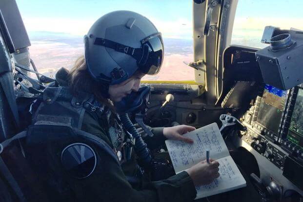 Military.com reporter Oriana Pawlyk takes notes during a B-1 training mission, Dec. 19, 2017. (Photo by Maj. Charles Kilchrist, 9th Bomb Squadron) 