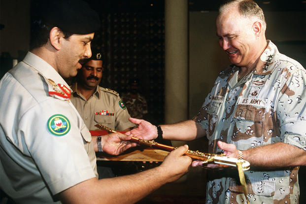 Bahraini Defense Minister Maj. Gen. Shaikh Khalifa Bin Ahmed Al-Khalifa presents U.S. Army Gen. Norman Schwarzkopf with a sword in recognition of his role in the allied success during Operation Desert Storm, March 26, 1991. (U.S. Army/Dean Wagner)