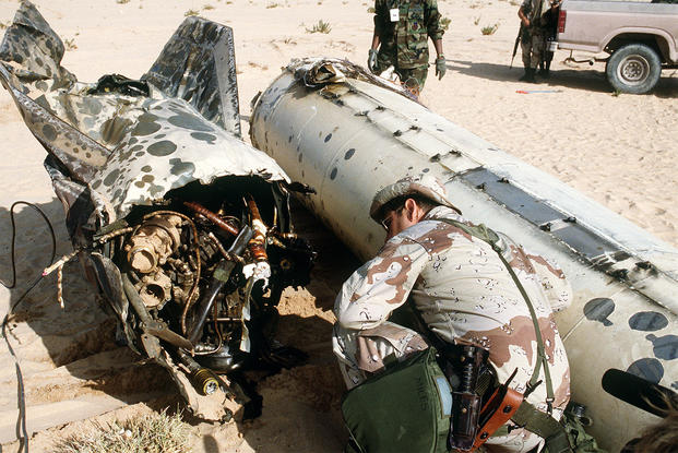 Air Force Senior Master Sgt. James Miles examines the tail section of a Scud missile shot down by a MIM-104C Patriot missile during Operation Desert Storm. (U.S. Air Force)