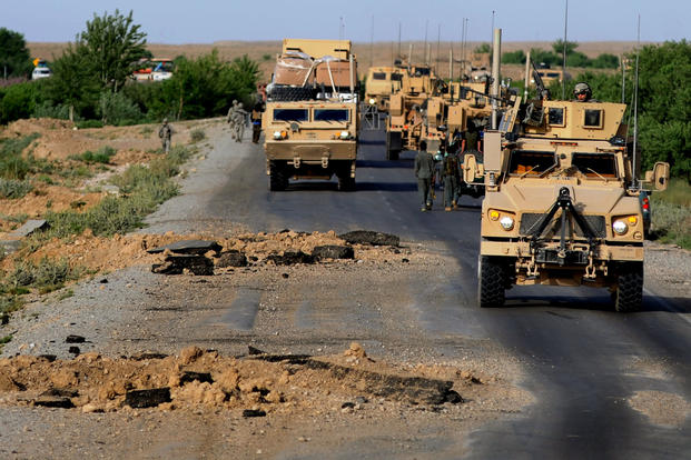 U.S. Army members with 782nd Alpha Company make their way around gigantic improvised explosive device blast holes that were created just a few hours prior to their convoy passing through April 30, 2010, Southern Afghanistan. (Photo: U.S. Army)