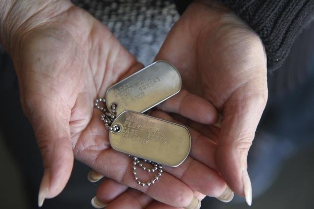 Joanna Mueller holds the identification tags of her uncle, U.S. Army Sgt. Floyd J.R. Jackson. Jackson, who was missing in action after the Battle of Chosin Reservoir, was assumed to be a prisoner of war. DNA evidence confirmed he died in a Korean POW camp around Dec. 12, 1950. (U.S. Army National Guard/Manda Walters/Released)