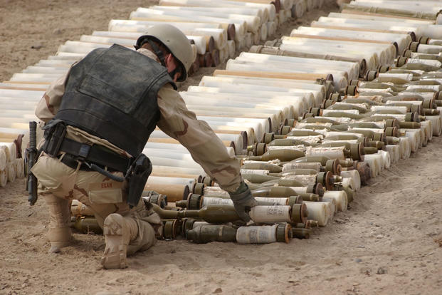 A U.S. Navy Explosive Ordnance Disposal (EOD) technician places C4 explosives on Chinese 82mm Type 65 Recoilless Rifles, and 82mm High Explosive Anti Tank (HEAT) Recoilless Rifle Rounds near the Kandahar International Airport in Afghanistan. (Photo: U.S. Navy/Photographer’s Mate 1st Class Ted Banks)