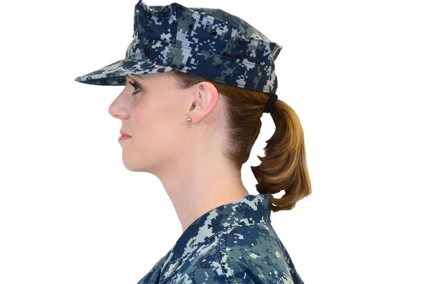 The end of the braid or ponytail may extend up to three inches below the lower edge of the collar of the shirt, jacket or coat. (U.S. Navy/Riley Eversull)
