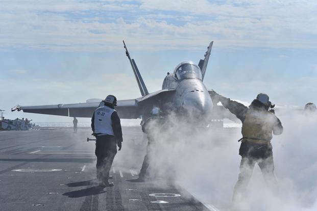 An F/A-18C Hornet assigned to the Salty Dogs of Strike Aircraft Test Squadron (VX) 23 tests the Joint Precision Approach Landing System (JPALS) aboard the aircraft carrier USS Theodore Roosevelt. (Stephane Belcher/U.S. Navy)