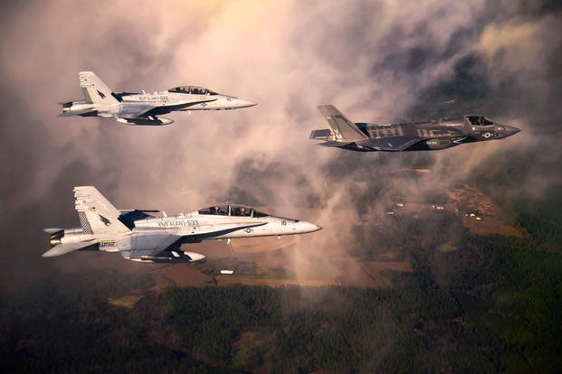 DoD's first production F-35B Lightning II joint strike fighter flies toward its new home at Eglin Air Force Base, Fla., escorted by Marine Corps F-18 Hornets, Jan. 11, 2011. (U.S. Air Force photo/Joely Santiago)