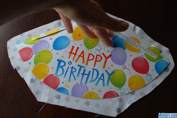Cut out the fabric for your care package birthday hat. (Military.com)