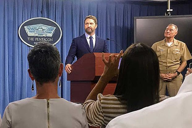 Actor Gerard Butler speaks to reporters at the Pentagon on Oct. 15, 2018, promoting his new movie, "Hunter Killer." Navy Vice Adm. Fritz Roegge stands to his right. Photo by Oriana Pawlyk/Military.com