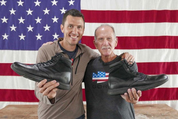 Jason McCarthy and Richard Rice display GORUCK's MACV-1 boot in front of an American flag. (Courtesy Photo)