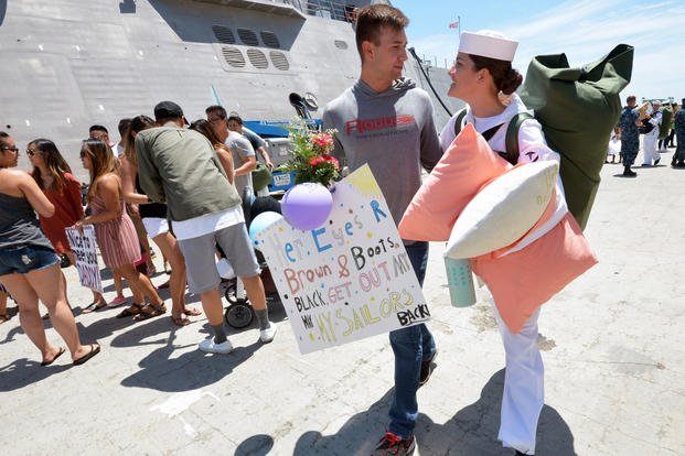 Hospital Corpsman 3rd Class Haley Buyense is greeted by Master-at-Arms 2nd Class Paul Peargen during a 2018 homecoming ceremony for the Military Sealift Command (MSC) hospital ship USNS Mercy. (U.S. Navy/Indra Beaufort)
