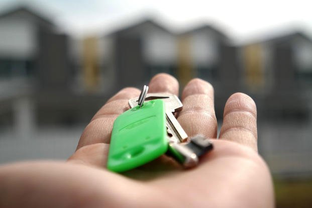 A man holds a house key. (Stock image)