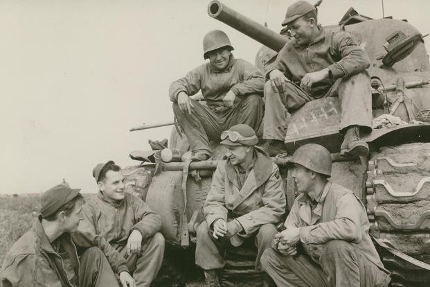Ernie Pyle with a tank crew from the 191st Tank Battalion, US Army at the Anzio Beachhead in 1944. (Army file photo via Wikimedia Commons)