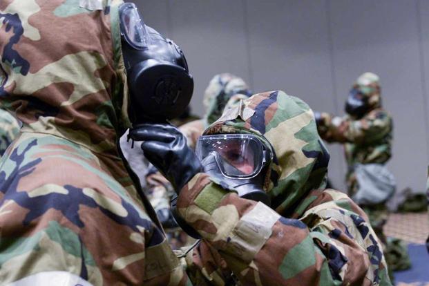 Airmen each other's MOPP gear to ensure proper protection.