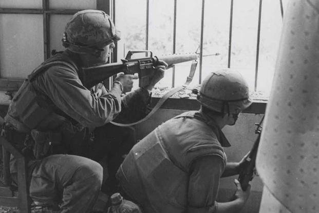 Marines A Company, 1st Battalion, 1st Marines fire from a house window during a search and clear mission in the Battle of Hue (Sgt. Bruce A. Atwell/U.S. Marine Corps photo)