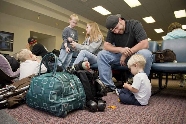 A family in the passenger terminal at Travis Air Force Base.