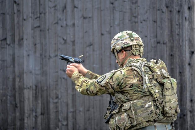 Soldier practices firing weapon.