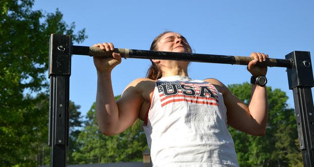 Pull-up is performed at Tough Mudder fitness challenge. 