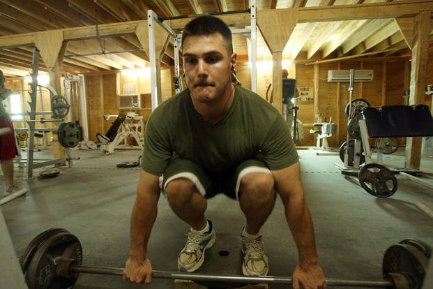 A former personal trainer helps other Marines with their exercise programs.