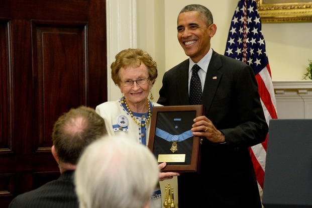 President Barack Obama and Helen Loring Ensign, a descendant of U.S. Army 1st Lt. Alonzo H. Cushing, hold an encased Medal of Honor during a ceremony at the White House in Washington, D.C.