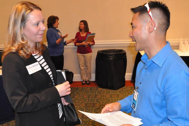 A Naval Surface Warfare Center Dahlgren Division (NSWCDD) representative discusses career opportunities with a candidate at the NSWCDD Career Fair in Virginia.