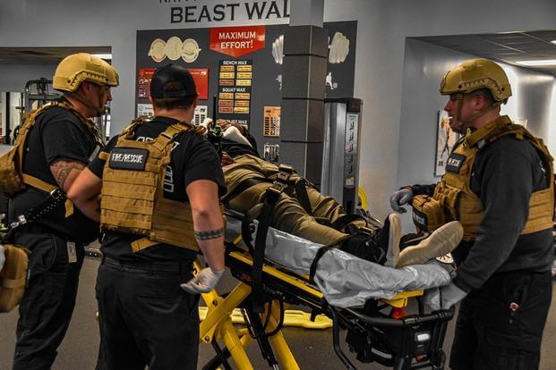 Fire and Emergency Services carry out a gunshot victim during an active shooter exercise conducted onboard Naval Support Activity Mid-South