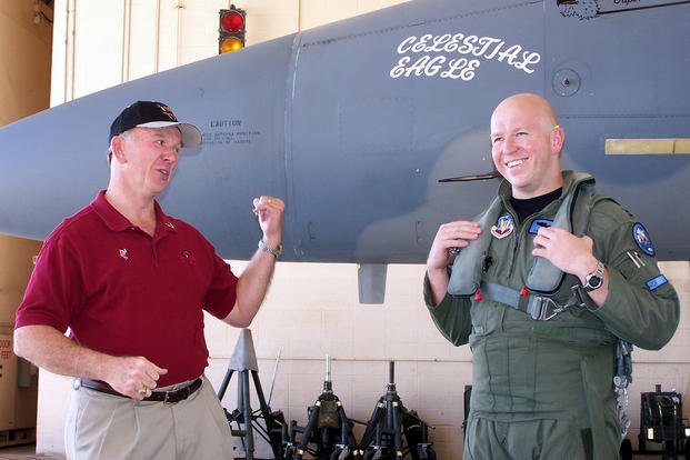 Retired Maj. Gen. Doug Pearson (left) and his son, Capt. Todd Pearson, joke with one another before Capt. Pearson took off on the Celestial Eagle remembrance flight at Homestead Air Reserve Base, Fla.