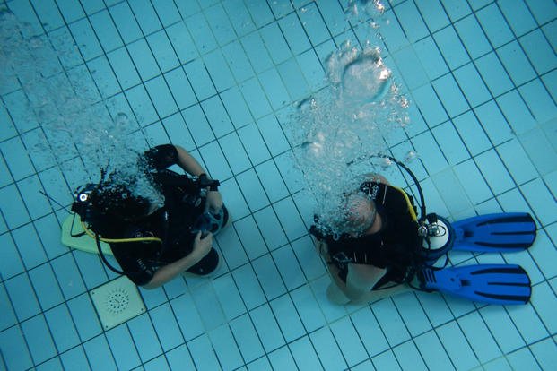 Erhard Bauman, Ramstein Aquatic Center’s Professional Association of Driving Instructors open water certification instructor, teaches a student during hands-on training at Ramstein Air Base, Germany.