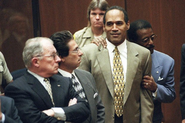 Attorney Johnnie Cochran Jr. holds O.J. Simpson as the not-guilty verdict is read in a Los Angeles courtroom during his murder trial in Los Angeles.
