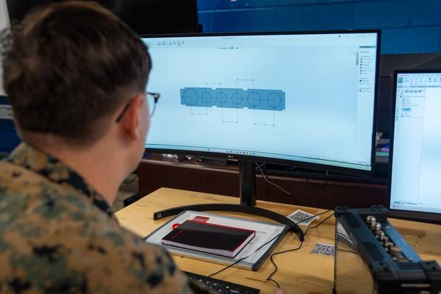 U.S. Marine Corps Cpl. Grant Morris, a digital wideband systems maintainer with 2nd Intelligence Battalion, II Marine Expeditionary Force Information Group, II MEF, designs a 3D model of a dust cover for a hand-held radio test set at Marine Corps Base Camp Lejeune, North Carolina, Sept. 4, 2025. Morris designed a dust cover for the hand-held radio test set during the additive manufacturing basic course hosted by the II MEF Innovation Campus. (U.S. Marine Corps photo by Lance Cpl. Brady V. Hathaway, DVIDS).