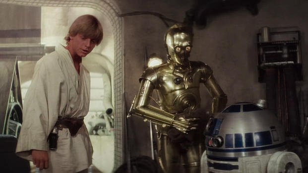 Luke Skywalker, played by Mark Hamill, standing with R2D2 and C3PO, on Tattooine in the 1977 classic Star Wars. Luke Skywalker, played by Mark Hamill, standing with R2D2 and C3PO, on Tattooine in the 1977 classic Star Wars.