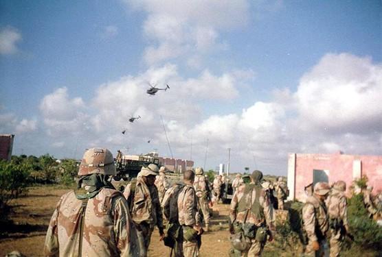 Army soldiers of Company B, 2nd Battalion, 14th Infantry Regiment, watch helicopter activity over Mogadishu, Oct. 3, 1993. Later the same day and throughout the night, the battalion's A and C Companies were part of a rescue convoy assembled for nearly 100 Rangers who had become trapped in the city after two Black Hawks were shot down. Army photo.