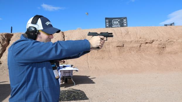 Everett Deger, marketing director for German gun-maker Walther, shows off the company's first-ever .45-caliber pistol, the PPQ 45, at range day as part of SHOT Show in Las Vegas, Jan. 18, 2016. (Photo by Brendan McGarry/Military.com.)