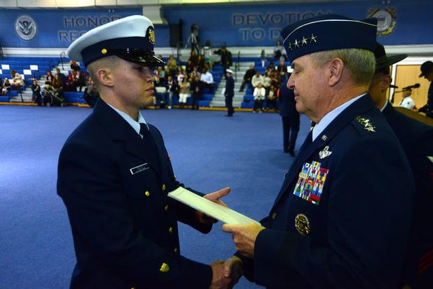 The Chief of Staff of the U.S. Air Force, Gen. Mark A. Welsh III, hands Seaman Patrick Knuth a graduation certificate, Friday, Jan. 29, 2016, at Coast Guard Training Center Cape May, N.J. (Photo: Chief Warrant Officer John Edwards)
