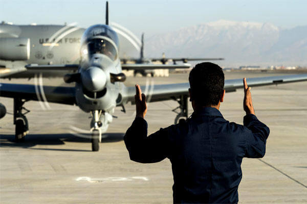 A member of the Afghan Air Force marshals in an A-29 Super Tucano at Hamid Karzai International Airport, Afghanistan, on Jan. 15. (US Air Force/Nathan Lipscomb)