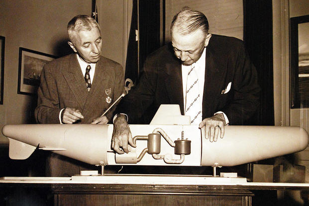  Secretary of the Navy Dan A. Kimball, (right), inspects a model of the Navy’s atomic submarine, the Nautilus after presenting Captain Hyman George Rickover, USN, (left), the Gold Star at ceremonies in his office at the Pentagon. (U.S. Navy photo)