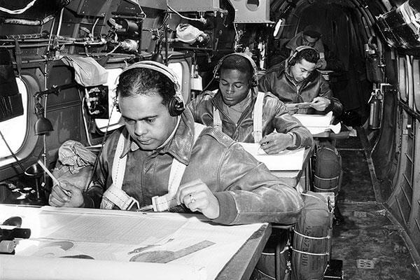 Tuskegee Airmen navigator cadets practice their skills in an airborne trainer in 1944. (National Archives)