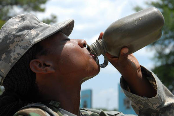 Soldier drinking water out of a canteen