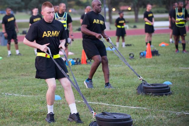 Pfc. Alex Colliver, front, pulls a 90-pound sled 50 meters that simulates the strength needed in pulling a battle buddy out of harm's way during a pilot for the Army Combat Readiness Test. (Photo Credit: U.S. Army photo by Sean Kimmons)