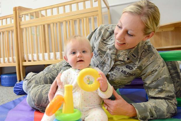 First Lt. Somer Lopez, 78th Force Support Squadron Customer Support chief, plays with baby. (U.S. Air Force photo by Tommie Horton)