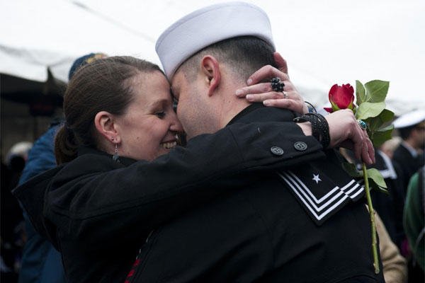 Wife with rose greets sailor.