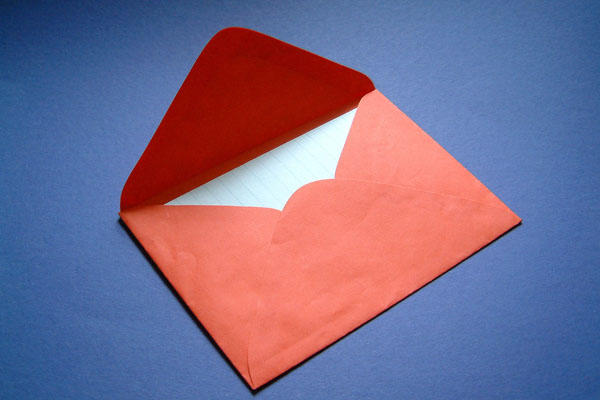 Red Valentine's day envelope with letter.