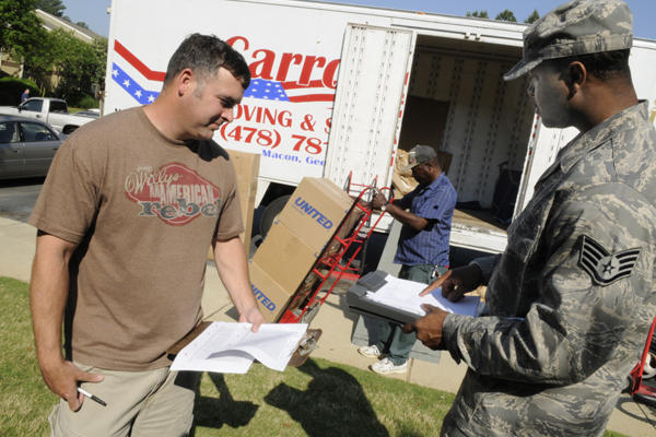 An Airman works with a moving crew during a PCS.