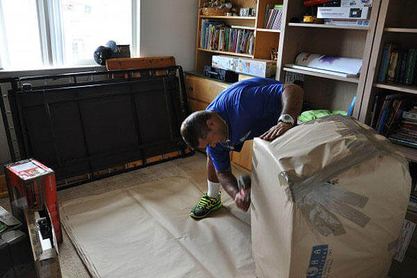 A mover wraps items in the Hunt household for a permanent change of station move.