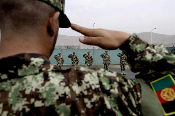 Afghan National Army officers salute during their inauguration ceremony at the Afghan Army Academy on the outskirts of Kabul, Afghanistan, Wednesday, Oct. 23, 2013. Army soldiers have easier access to education through this academy. Rahmat Gul / AP