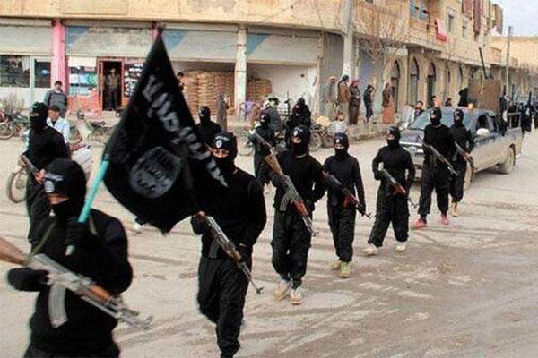 In this undated file image posted on a militant website on Tuesday, Jan. 14, 2014, fighters from the al-Qaida linked Islamic State group, march in Raqqa, Syria. (AP Photo/File)