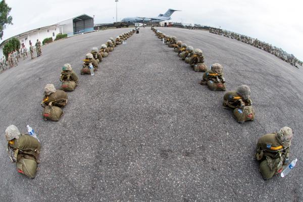 About 70 parachutes and helmets sit on a flight line in preparation for airborne operations during this year’s Central Accord exercise in Libreville, Gabon, June 15, 2016. (Photo by Brian Kimball/Defense Department)