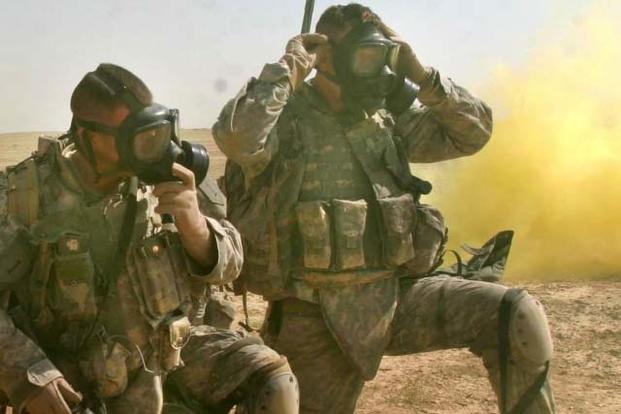 Soldiers don and clear their masks during training for a chemical attack. (Photo Credit: Marine Corps Sgt. Andrew D. Pendracki)