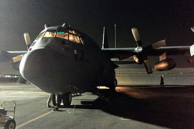 A C-130 Hercules sits on a dark runway for a post-flight inspection. C-130s are often involved in a dignified transfer to move bodies to other aircraft, such as C-17 Globemaster IIIs, bound for the United States. (Photo Oriana Pawlyk)