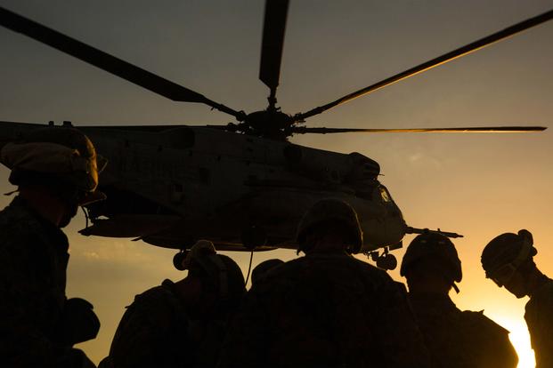 Marine Infantry Officer Course students await a CH-53E Super Stallion helicopter fast rope drill on the Marine Corps Air Station Yuma, Ariz., Auxiliary Landing Field 2, Wednesday, August 18, 2014. (U.S. Marine Corps/ Cpl. James Marchetti)